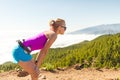 Young woman running in mountains on sunny summer day Royalty Free Stock Photo