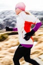 Young woman running in mountains on winter fall Royalty Free Stock Photo