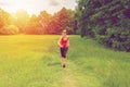 Young woman running outdoor with strong light. Royalty Free Stock Photo