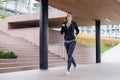 Young woman running outdoor in urban enviroment Royalty Free Stock Photo