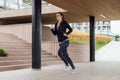 Young woman running outdoor in urban enviroment Royalty Free Stock Photo