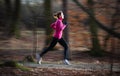 Young woman running outdoors in a city park Royalty Free Stock Photo