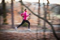 Young woman running outdoors in a city park Royalty Free Stock Photo