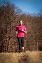 Young woman running outdoors in a city park Royalty Free Stock Photo