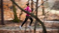 Young woman running outdoors in a city park Royalty Free Stock Photo