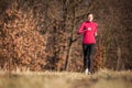 Young woman running outdoors in a city park Royalty Free Stock Photo