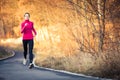 Young woman running outdoors in a city park Royalty Free Stock Photo