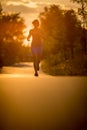 Young woman running outdoors on a lovely sunny summer evenis Royalty Free Stock Photo