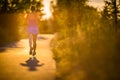 Young woman running outdoors on a lovely sunny summer evenis