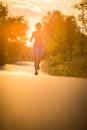 Young woman running outdoors on a lovely sunny summer evening Royalty Free Stock Photo