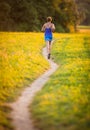 Young woman running outdoors on a lovely sunny summer evening Royalty Free Stock Photo