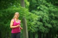 Young woman running in the park at her leisure Royalty Free Stock Photo