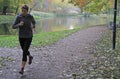 Young woman is running in park of Warsaw Royalty Free Stock Photo