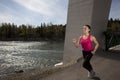 Young Woman Running Beside River Royalty Free Stock Photo