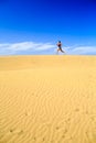 Young woman running on sand desert dunes Royalty Free Stock Photo