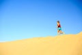 Young woman running on sand desert dunes Royalty Free Stock Photo