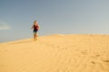 Young woman running on sand desert dunes Royalty Free Stock Photo