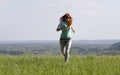 Young woman running on spring meadow Royalty Free Stock Photo