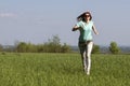 Young woman running on spring meadow Royalty Free Stock Photo