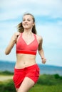 Young woman running summer park rural road. Outdoor exercises. J Royalty Free Stock Photo