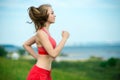 Young woman running summer park rural road. Outdoor exercises. J Royalty Free Stock Photo