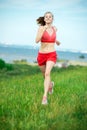 Young woman running summer park rural road. Outdoor exercises. J Royalty Free Stock Photo