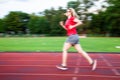 young woman on running track motion blur