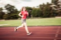 young woman on running track motion blur