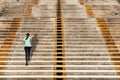 Woman running up in urban stairs concrete background Royalty Free Stock Photo