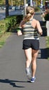 Young woman runs on the city street