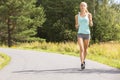 Young woman runs outdoor in the forest