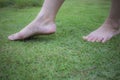 Young woman`s barefoot walking on the fresh, green grass in sunny summer in the morning. Restful moment. Healthy lifestyle. Brigh Royalty Free Stock Photo