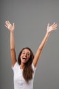 Young woman's emotional portrait raising arms and open hands