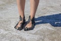 Young woman`s feet covered with black dirt Royalty Free Stock Photo