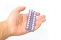 Young woman's hand holding birth control pills Royalty Free Stock Photo