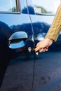 Young woman's hand unlocking her car outdoors. Royalty Free Stock Photo