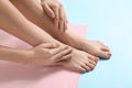 Legs and hands of young woman with beautiful pedicure and manicure on color background Royalty Free Stock Photo