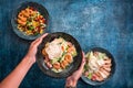 A young woman& x27;s hands holding Asian fish salad with fresh micro green and vegetables Royalty Free Stock Photo