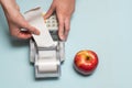 A young woman`s hands tearing a check from a cash register after purchasing a product, entering a discount on a market Royalty Free Stock Photo