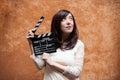 Young woman 70s hippie style closeup with clapperboard Royalty Free Stock Photo