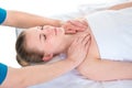 Young woman`s shoulder joints being manipulated by an osteopath - an alternative medicine treatment