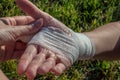 A young woman's wrist joint, correctly tied with a bandage, is shown. Injured while hiking in the open air. First aid Royalty Free Stock Photo