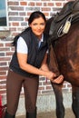 Young Woman Saddling Her Horse