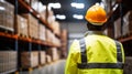 Young woman in safety helmet at logistic center with blurred background and copy space