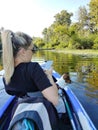 A young woman is sailing on a boat with her jack russell terrier dog and taking a photo of her on a mobile phone Royalty Free Stock Photo