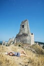 Young woman in a sailor outfit lying on the dry grass and behind Royalty Free Stock Photo