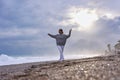 Young woman on the sand beach and watching the sea waves. Royalty Free Stock Photo