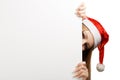 Young woman in santa claus hat with christmas card