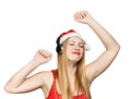 Young woman in santa claus hat and headphones take pleasure from
