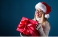 Young woman with santa hat holding a gift box Royalty Free Stock Photo